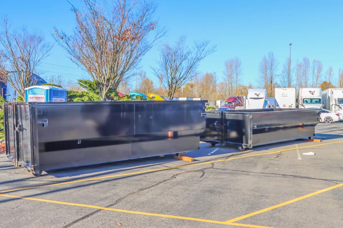 Professional dumpster rental service with roll-off container on residential driveway in Sudbury